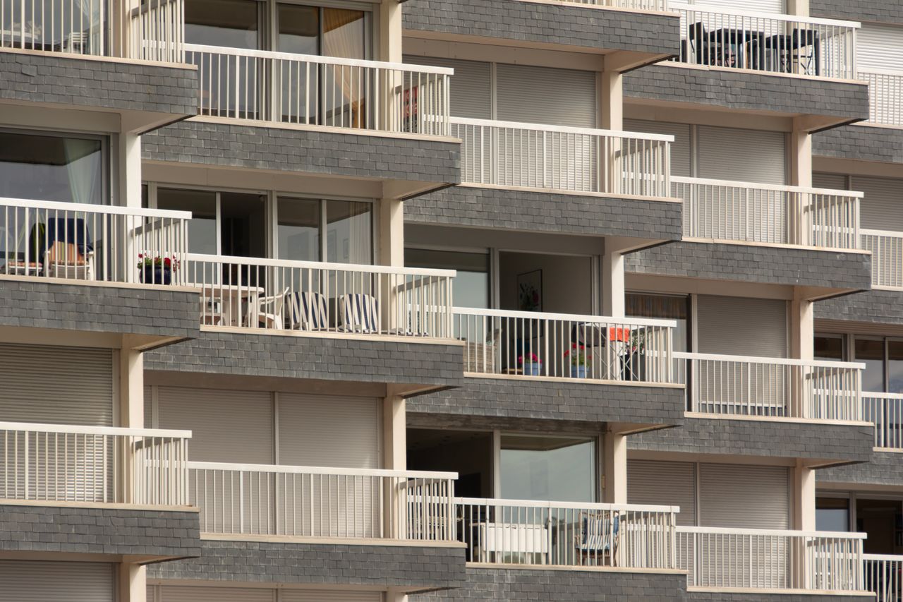 About Modern apartment building facade with multiple balconies, showcasing urban architecture.